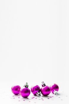 Christmas and New Year background with magenta purple decorative balls for Christmas tree. Place for text.