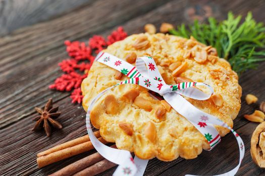 Christmas and New Year 2017 background with peanut tart and decorations - snowflake, ribbon, spices. Place for text.