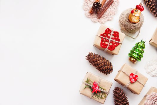 Christmas and New Year background with handmade presents wrapped in craft paper and decorations, holiday symbols. Place for text.