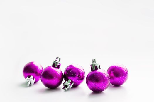 Christmas and New Year background with magenta purple decorative balls for Christmas tree. Place for text.