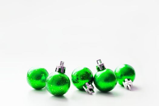 Christmas and New Year background with green decorative balls for Christmas tree. Place for text.
