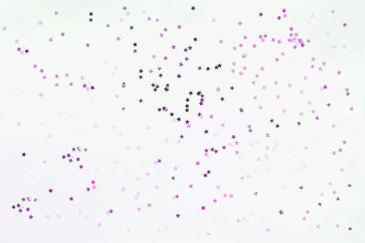 Holiday background with silver and violet star confetti. Good background for Christmas and New Year cards.