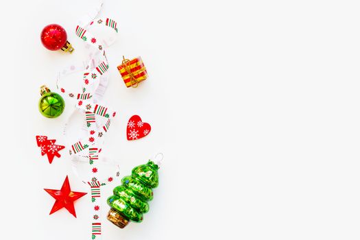 Ribbon with Christmas pattern - nordic geometric snowflakes. New Year decorations - bright colorful balls, fir tree, star. Place for text. Flat lay, top view.