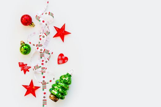 Ribbon with Christmas pattern - nordic geometric snowflakes. New Year decorations - bright colorful balls, fir tree, star. Place for text. Flat lay, top view.