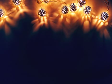 Dark background with light bulbs. Metal light bulbs with delicate pattern. Holiday background with place for text.