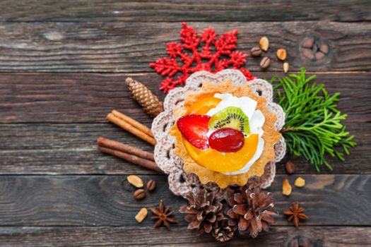 Christmas and New Year 2017 background with fruit tart and decorations - snowflake, crochet napkin, pine cones. Place for text.