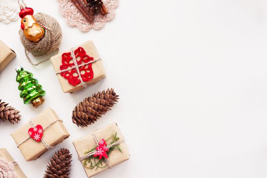 Christmas and New Year background with handmade presents wrapped in craft paper and decorations, holiday symbols. Place for text.