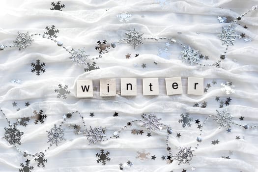 Winter background with decorative sparkling snowflakes and word WINTER.