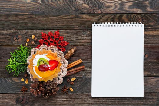 Christmas and New Year 2017 background with fruit tart and decorations - snowflake, crochet napkin, pine cones. Place for text.
