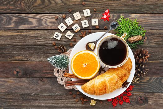 Christmas and New Year 2017 background with continental breakfast - cup of hot coffee with cinnamon, fresh orange and croissant. Decorations - snowflake, crochet napkin, pine cones.