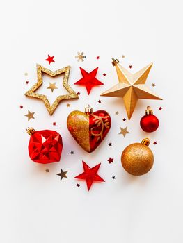 Christmas and New Year 2020 background with decorations, shaped as a circle. Golden and red balls, stars, confetti and heart.