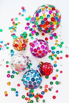 Christmas and New Year background with decorations - bright balls, hand made with colorful sparkling spangles.