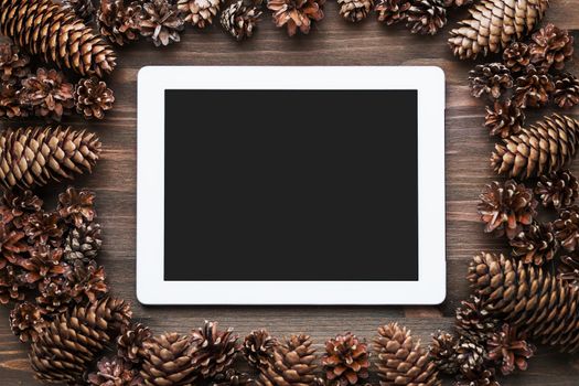 Rustic wooden background with tablet. Mock up, top view, flat lay. Place for text.
