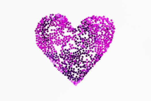 Heart made of sparkling magenta purple conffetti. Shining symbol of love on white background.