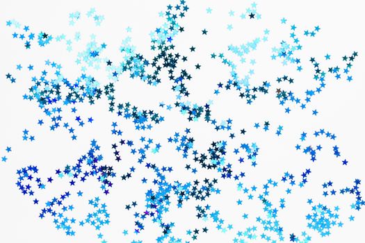 Holiday background with blue star confetti. Good background for Christmas and New Year cards.