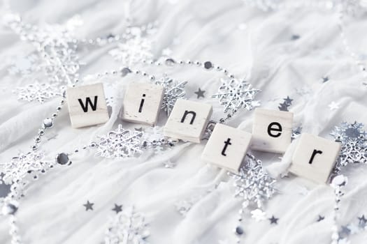 Winter background with decorative sparkling snowflakes and word WINTER.