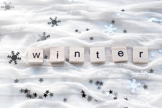 Winter background with decorative sparkling snowflakes and word WINTER.