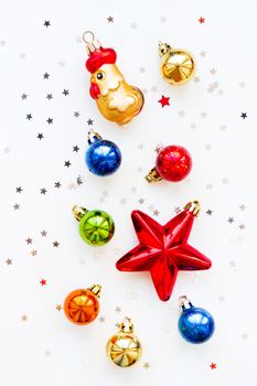 Christmas background with decorations. Shiny colorful balls, star and confetti. Flat lay, top view.
