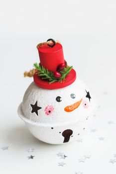 Christmas and New Year background with Snowman decorative ball for Christmas tree. Holiday background with stars confetti.