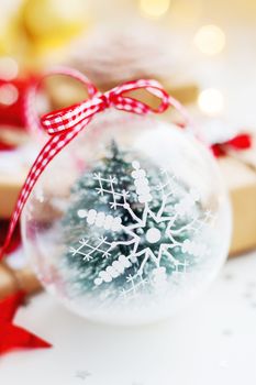 Christmas and New Year background with snowflake decorative ball, presents and decorations for Christmas tree. Holiday background with stars confetti and light bulbs. Place for text.