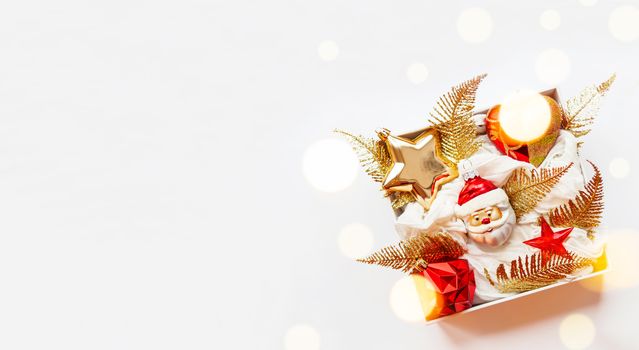 Banner - white box with New Year decorations. Bright red and golden decorative toys for Christmas tree.
