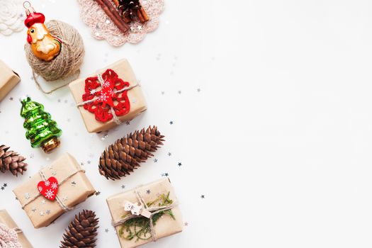 Christmas and New Year background with handmade presents wrapped in craft paper and decorations, holiday symbols. Place for text.