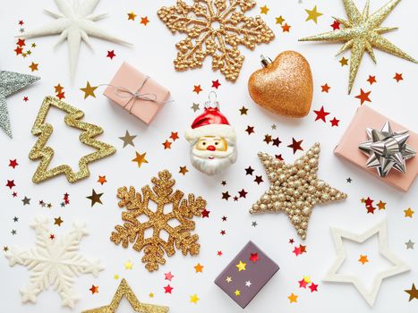 Christmas and New Year background with sparkling fir tree, Santa Claus, heart, snowflakes and star confetti. Holiday decorations on white background.