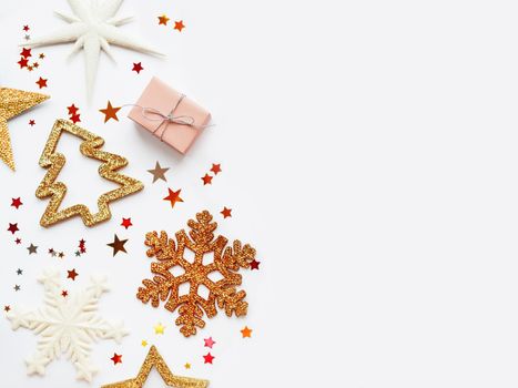 Christmas and New Year background with sparkling fir tree, snowflakes and star confetti. Holiday decorations on white background.