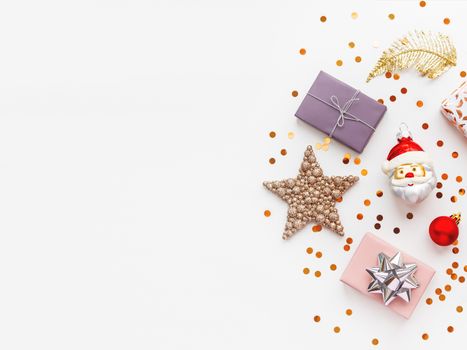 Christmas and New Year 2020 background with decorations. Santa Claus, golden feathers, presents and stars confetti.
