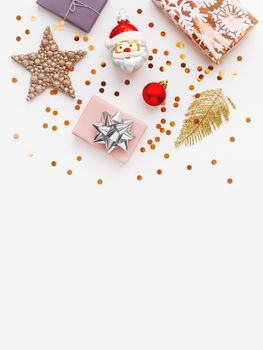 Christmas and New Year 2020 background with decorations. Santa Claus, golden feathers, presents and stars confetti.