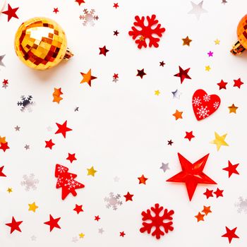 Christmas and New Year holiday background with decorations and clear round background in center. Shiny balls, felt snowflakes and star confetti. Flat lay, top view.