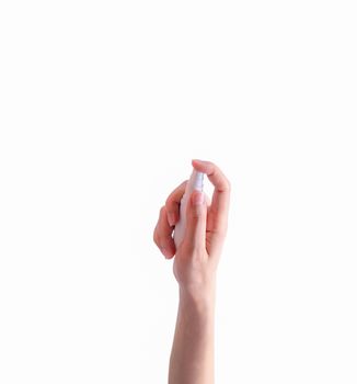 Woman hand hold alcohol plastic bottle and finger press spray pump isolated on white background. Personal hygiene to prevent coronavirus or flu epidemic. Cleaning hands from germs, virus, bacteria. 