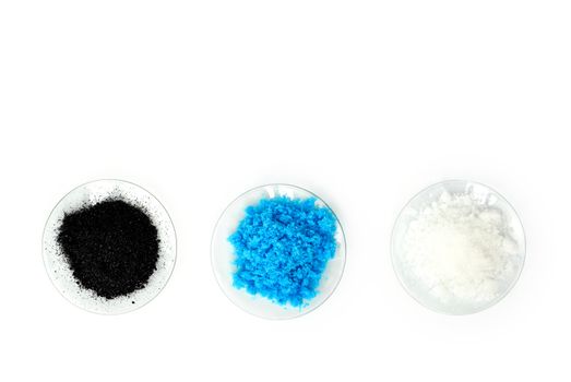 Cosmetic chemicals ingredient on laboratory table. Copper(II) sulfate, Potassium chloride, Potassium permanganate. (Top View)