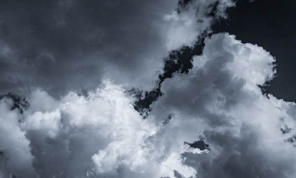 Dark dramatic sky and clouds. Background for death and sad concept. Gray sky and fluffy white clouds. Thunder and storm sky. Sad and moody sky. Nature background. Dead abstract background. Cloudscape.