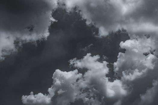 Dark dramatic sky and clouds. Background for death and sad concept. Gray sky and fluffy white clouds. Thunder and storm sky. Sad and moody sky. Nature background. Dead abstract background. Cloudscape.