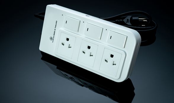 Power strip with three electrical standard socket on black background. White universal plug with overload protection. Fire resistant material for cover. Circuit breaker. Individual switch. Power plug.