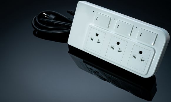 Power strip with three electrical standard socket on black background. White universal plug with overload protection. Fire resistant material for cover. Circuit breaker. Individual switch. Power plug.