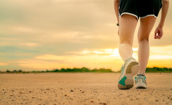 Athlete woman runner getting ready for start training run at the park in the morning. Woman wear sport shoes for race. Asian female cardio exercise for healthy life. Fit girl training for marathon.