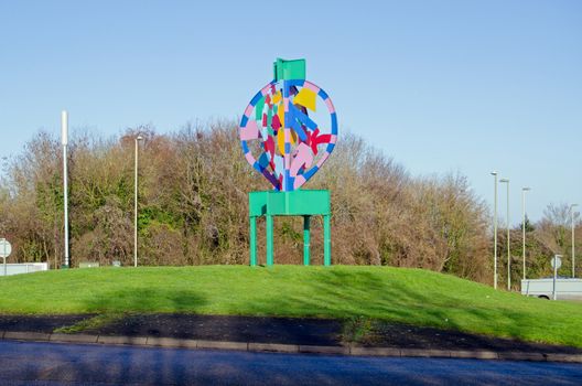 Colourful sculpture marking the centre of the Hatchwarren Roundabout in the south of Basingstoke, Hampshire.  The town is renowned for its traffic islands and is sometimes referred to as donought city.