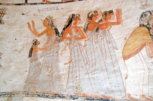 Decoration on the tomb of Amenemonet, a priest of the Ramesside Period, showinig a group of female mourners in distress.  Ancient mural, thousands of years old sited on the West Bank of the Nile at Luxor, Egypt.