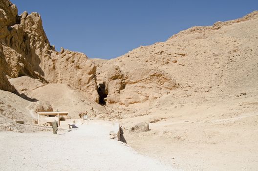 A custodian walks towards one of the tombs open to the public in the historic Valley of the Queens in Luxor, Egypt.  Ancient Egyptian royalty were buried in this valley in what was the city of Thebes.
