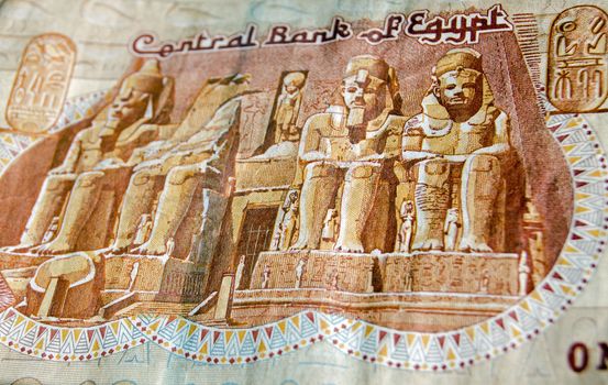 The famous Abu Simble Temple on the front of a one pound banknote from Egypt. Used banknote, photographed at an angle.