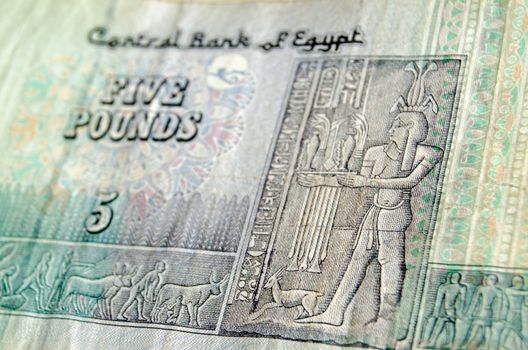 The Ancient Egyptian god Hapi, representing the bounty of the Nile, on the front of a five pound banknote from Egypt.  Used banknote, photographed at an angle.