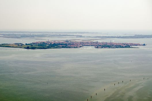 Aerial view of the Venetian Lagoon with the island of Murano to the fore and behind it the less populated Le Vignole and Saint'Erasmo with the Adriatic Sea beyond.