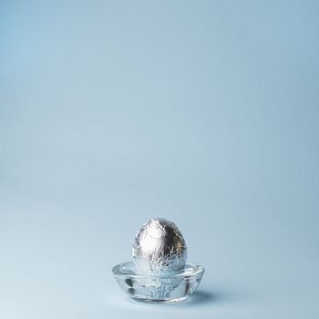 an egg wrapped with a sheet of aluminum foil