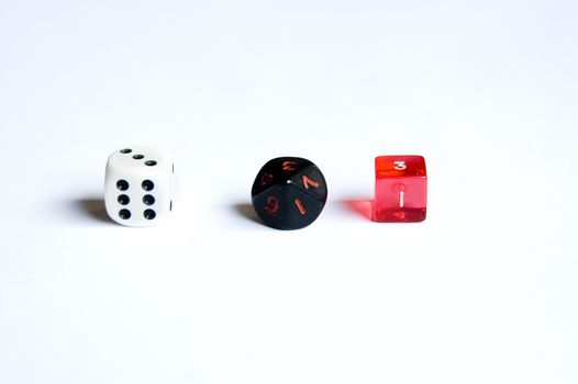 small various dice lying on a white isolated background