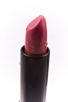 beautiful red lipstick in a black body on a white isolated background