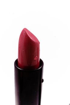 beautiful red lipstick in a black body on a white isolated background