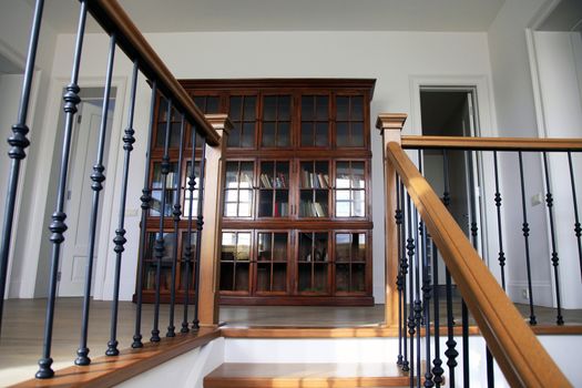 The wooden ladder conducting on the second floor