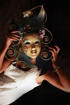 girl in a venetian mask on a dark background